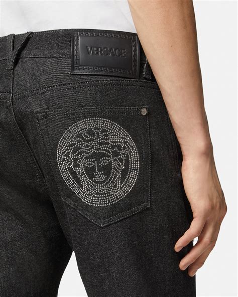 young versace medusa studded jeans